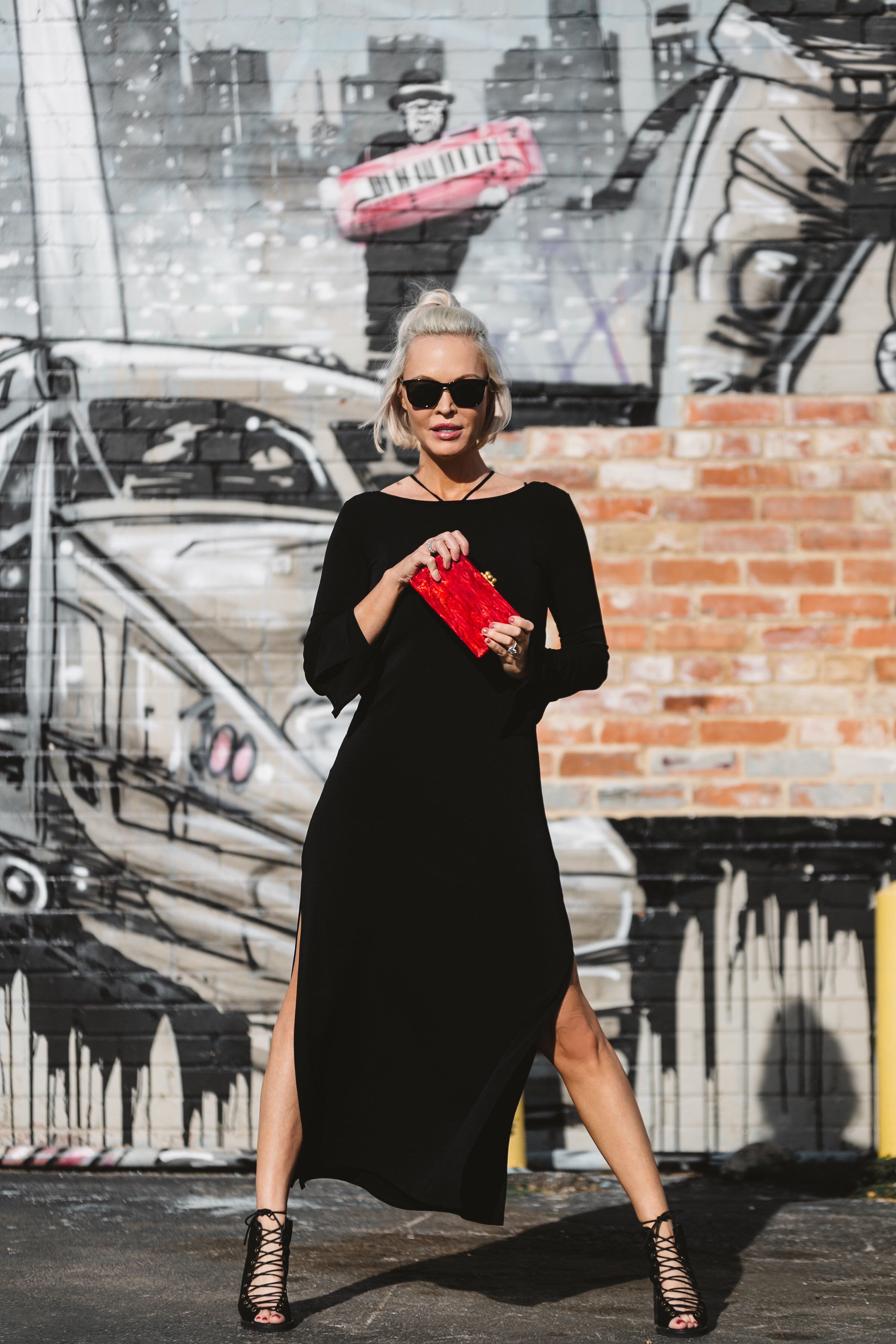 little black dress paired with red clutch