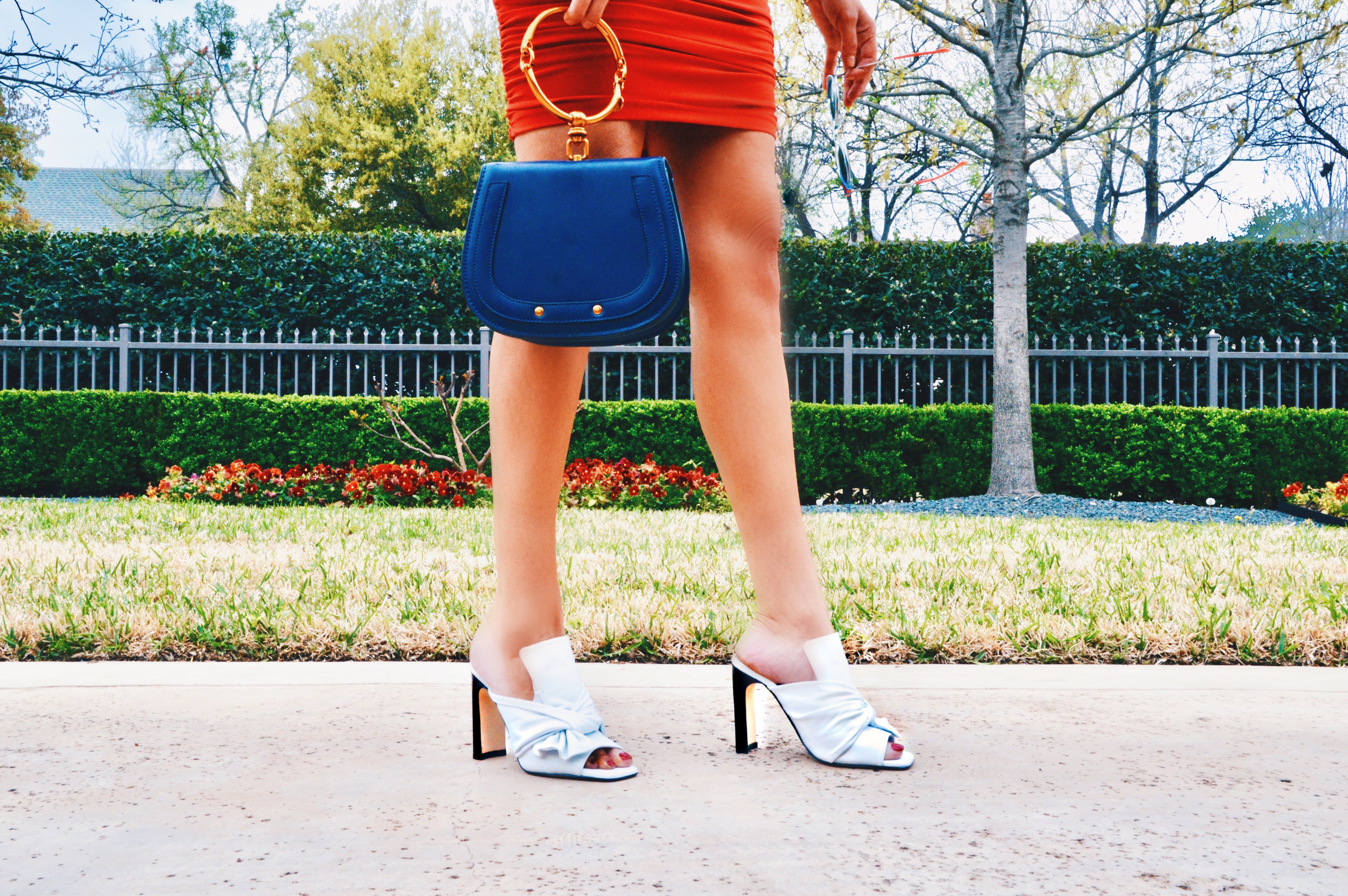 the color red can be paired with heels and a blue purse