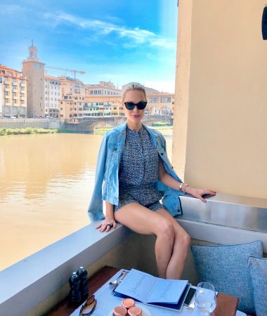 whitney in front of river and buildings in florence