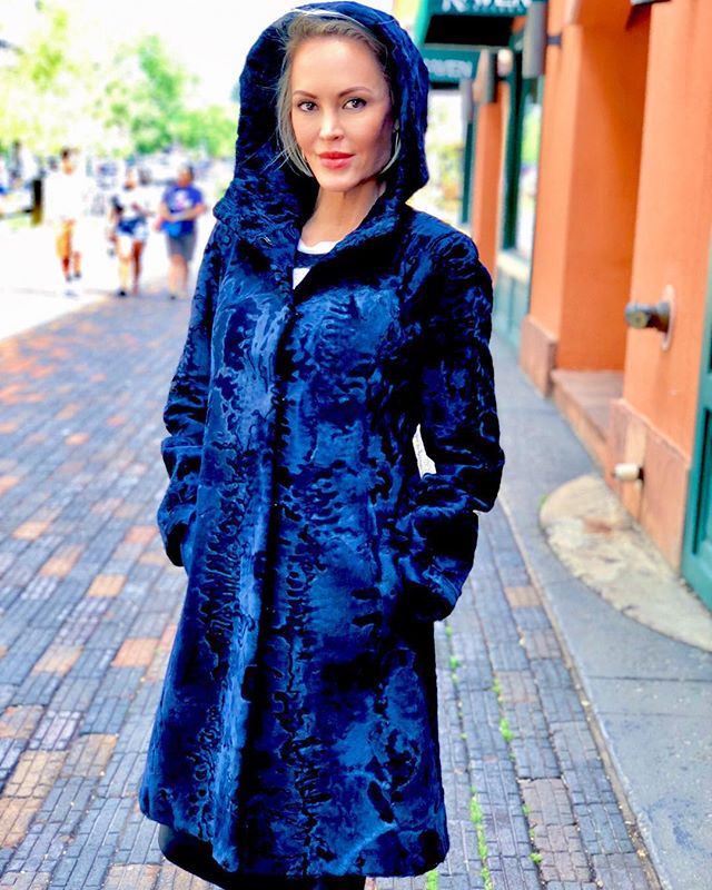 wearing a blue winter coat in aspen