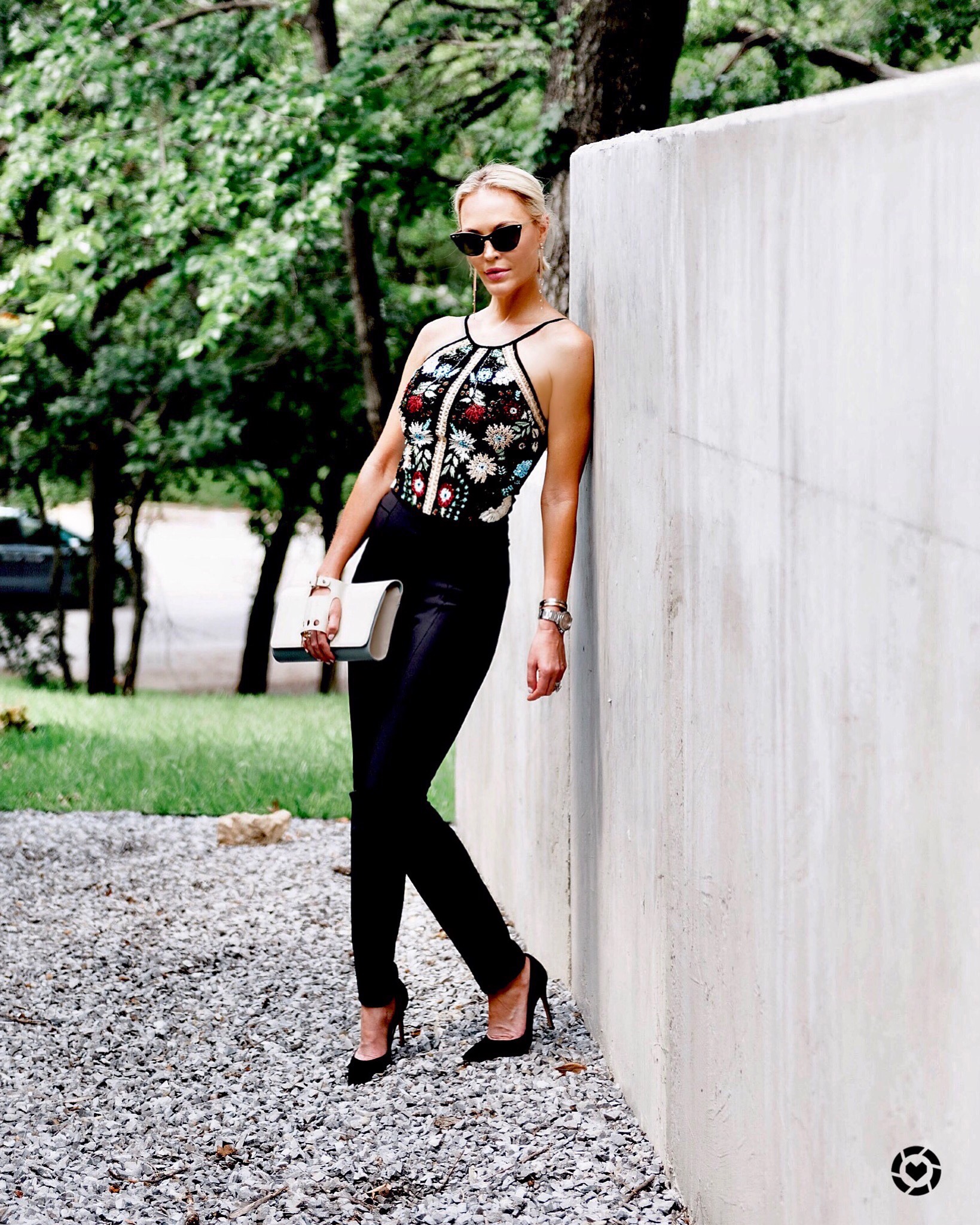 floral sleeveless fashion top and dark pants