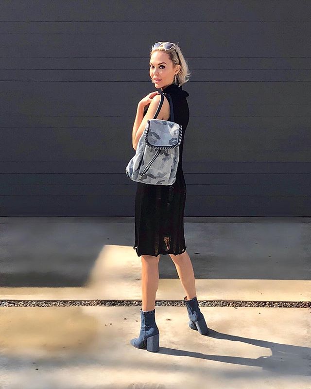 february fashion outfit with black dress and camo bag