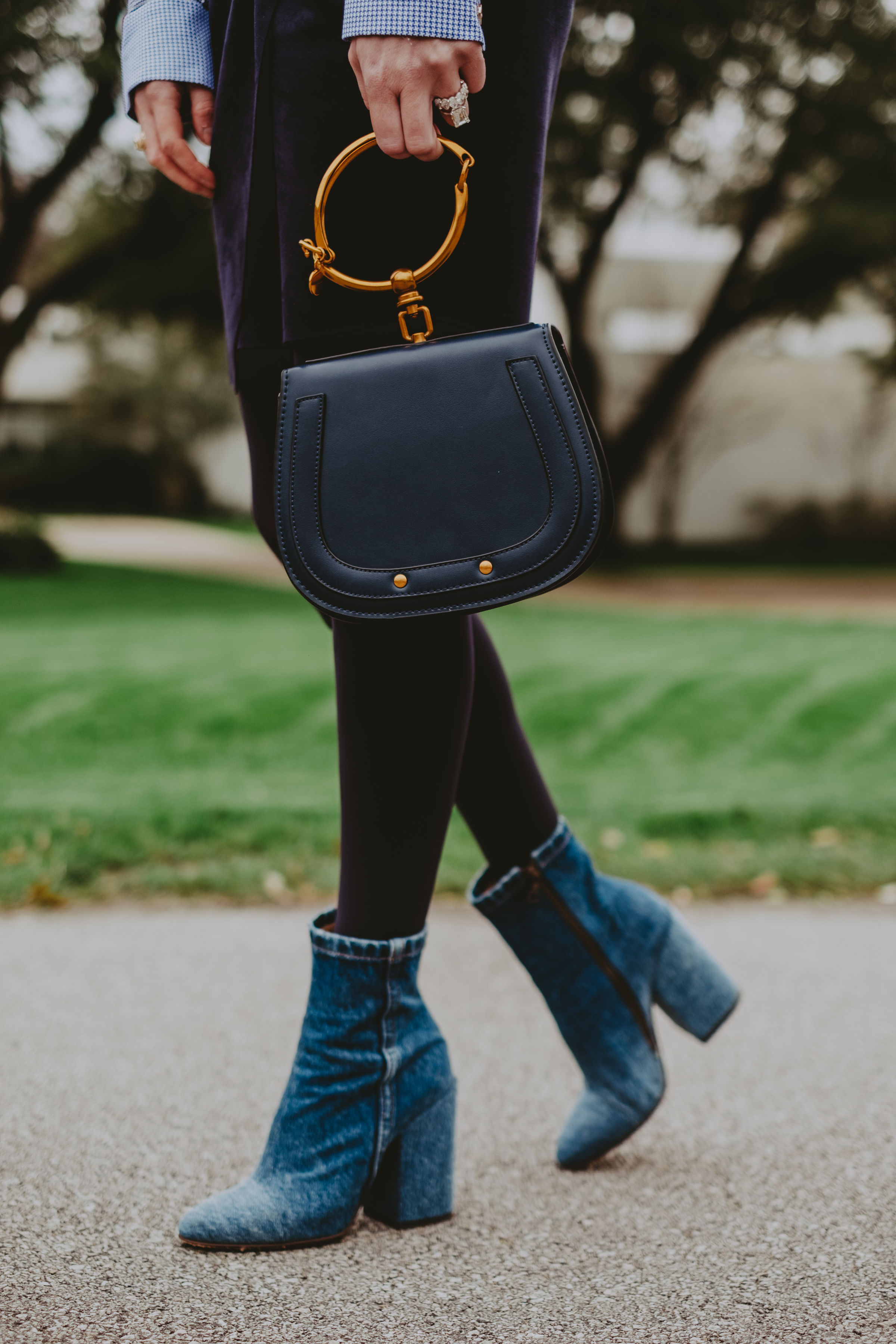 navy purse paired with blue boots