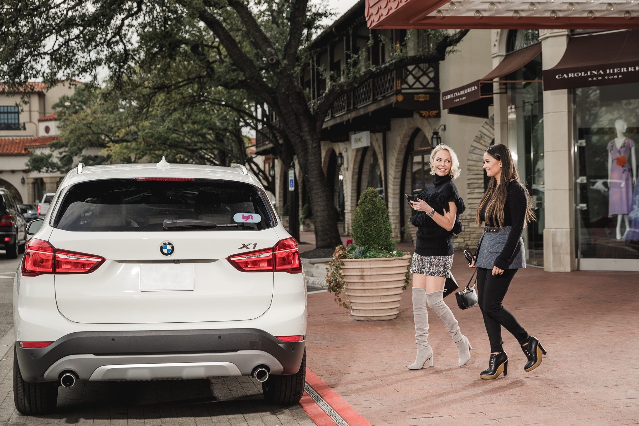 Whitney and Catherine Lowe laughing and getting into a Lyft