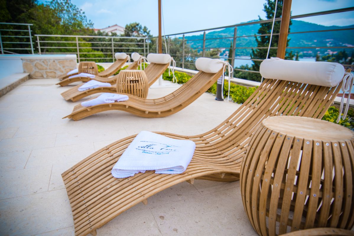 poolside view with beach chairs and luxury towels