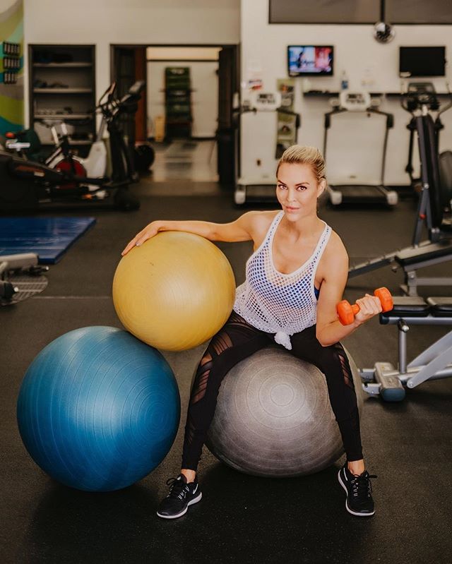 lifting weights in the gym with balance balls