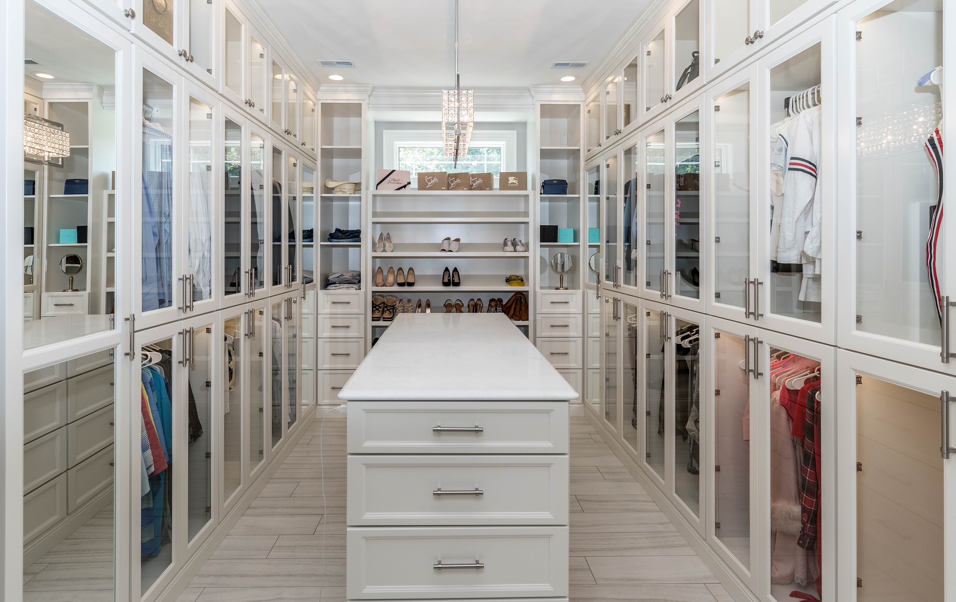 large, organized closet with mirrors