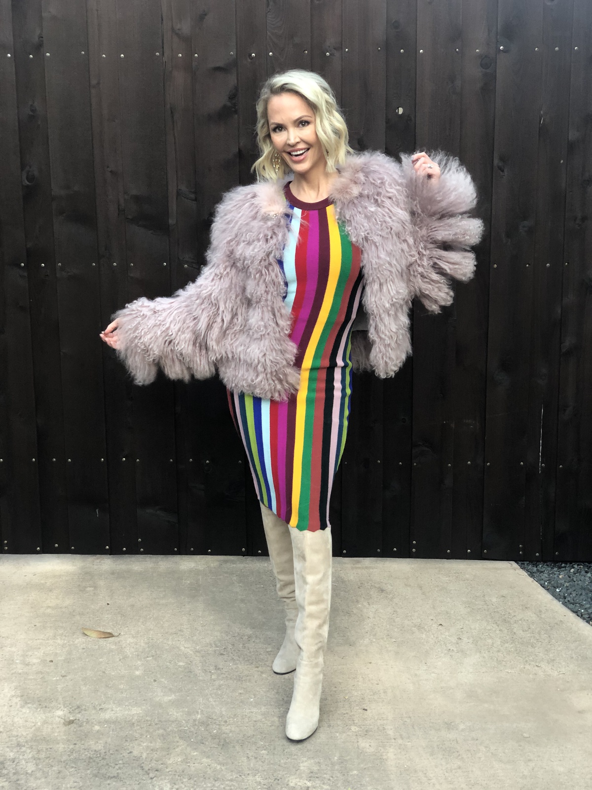 colorful striped dress with pale pink faux fur coat