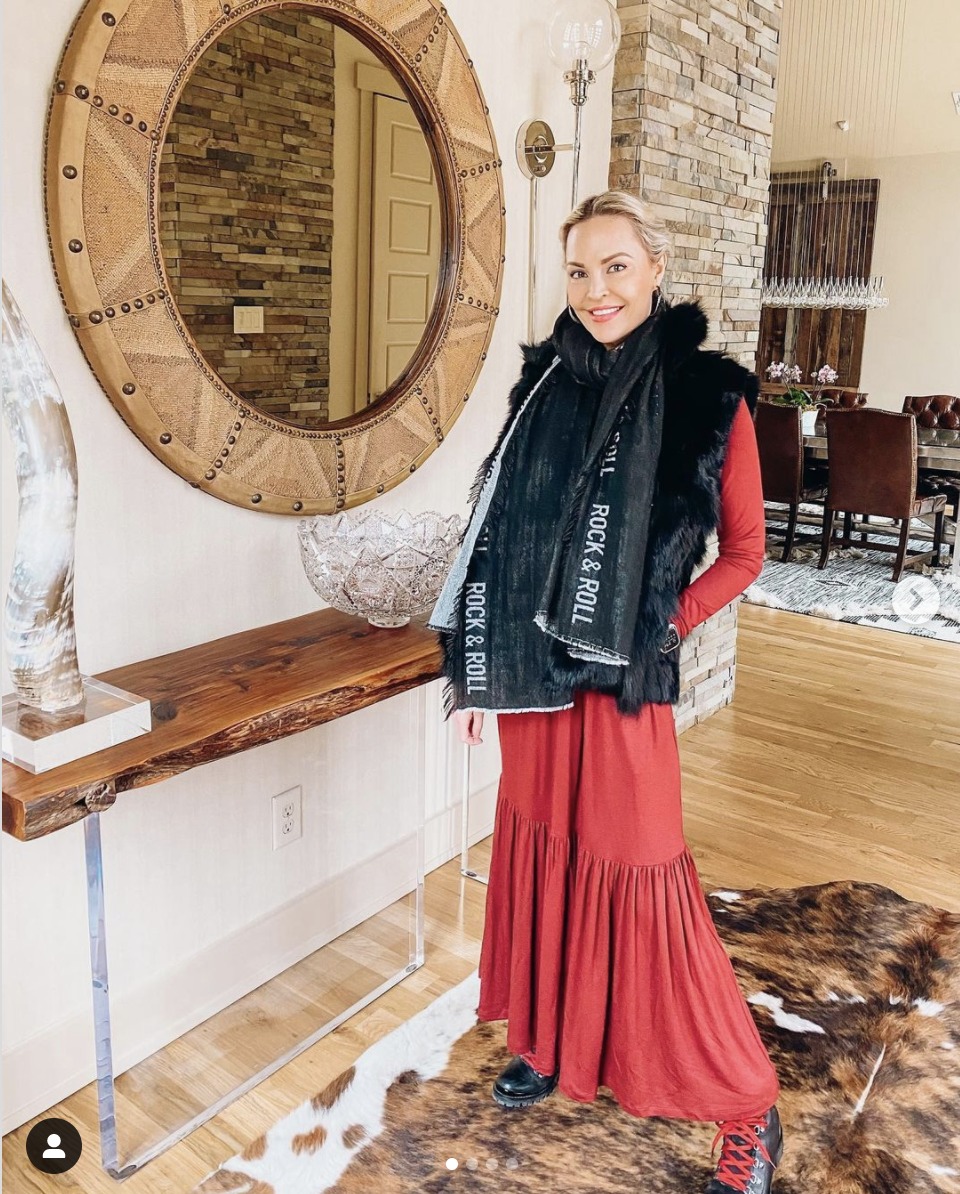 layered outfit with a red dress and black vest